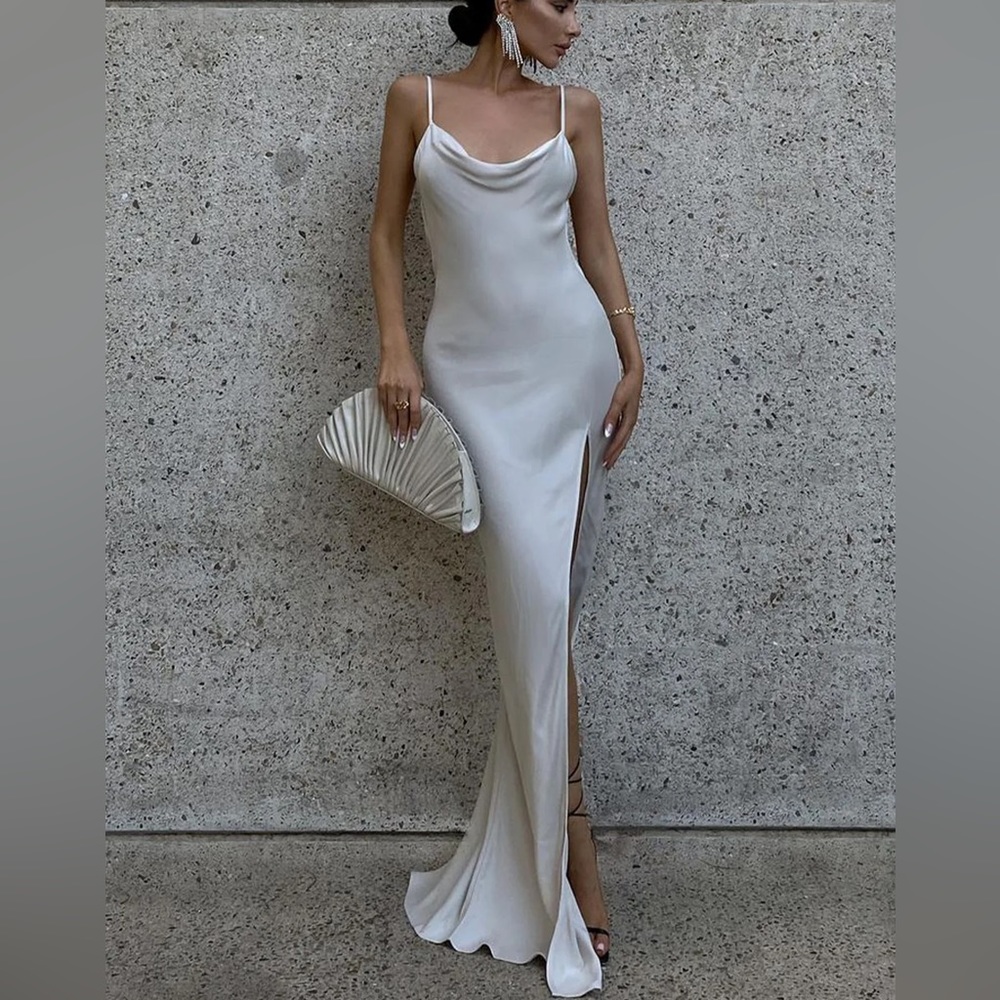 Elegant white silk dress with open slip on the leg and a opened back